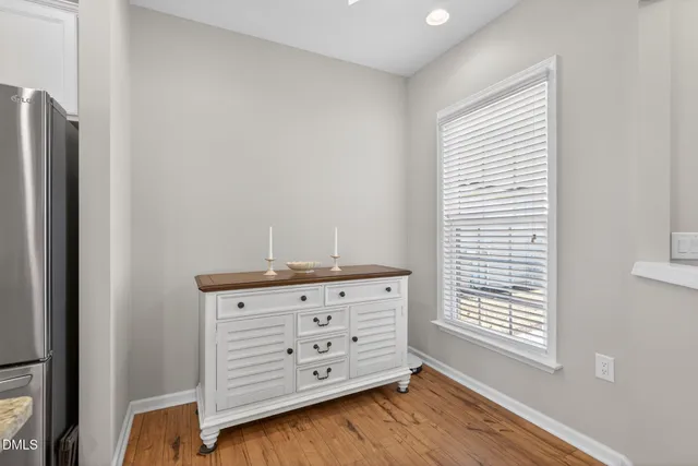 a view of a dresser with window in wooden floor