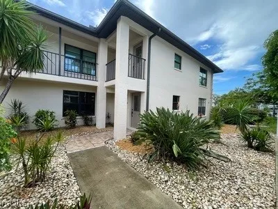a view of a house with a yard and plants