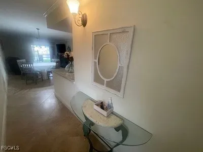 a living room with furniture and a mirror