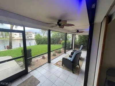 a living room with furniture and a floor to ceiling window