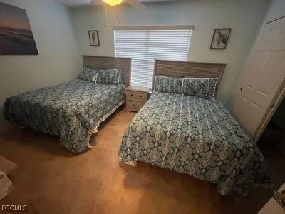 a bedroom with a bed and a night stand
