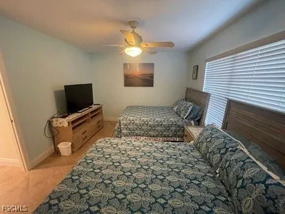 a bedroom with a bed and flat screen tv