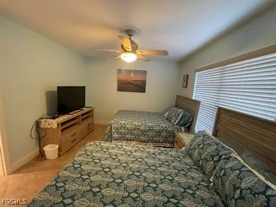 a bedroom with a bed and flat screen tv