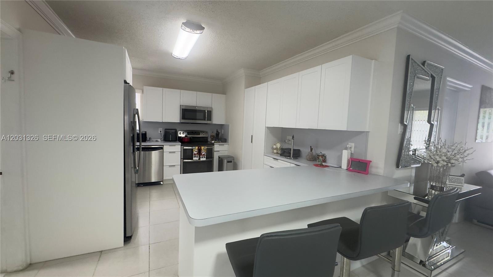 12480 Southwest 189th Street Miami, FL 33177 - Photo 6 of 25 a kitchen with a table and chairs in it