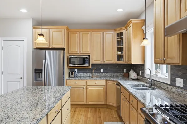 a kitchen with a sink stove and refrigerator