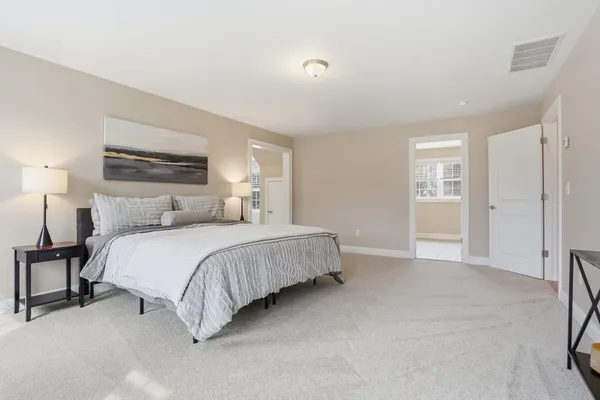 a bedroom with a bed and a painting