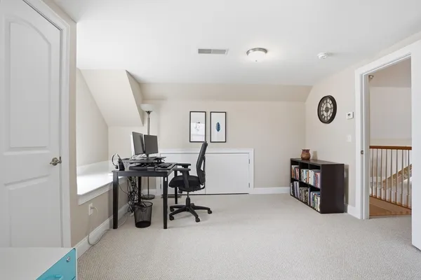 a view of a livingroom with furniture and a window