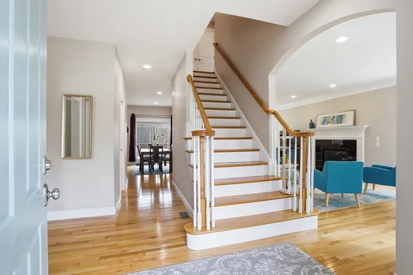 a view of a hallway with wooden floor and staircase