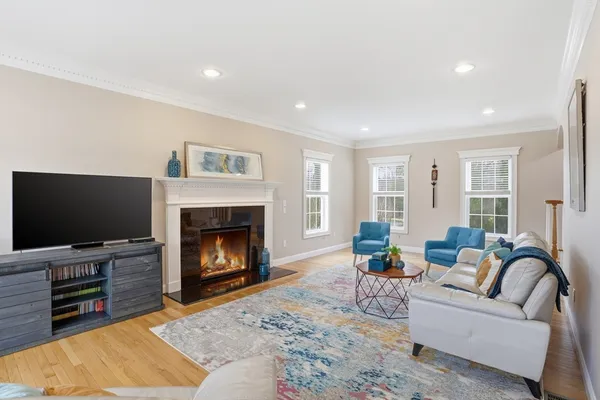 a living room with furniture a flat screen tv and a fireplace