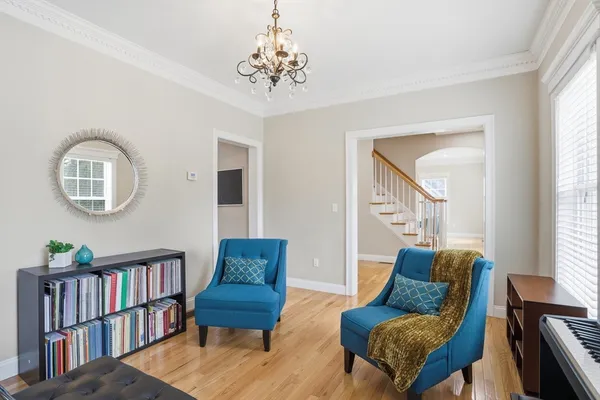 a living room with furniture and a book shelf