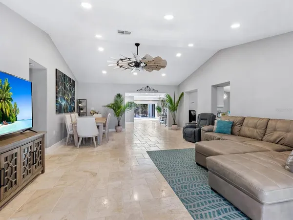 a living room with furniture large window and flat screen tv