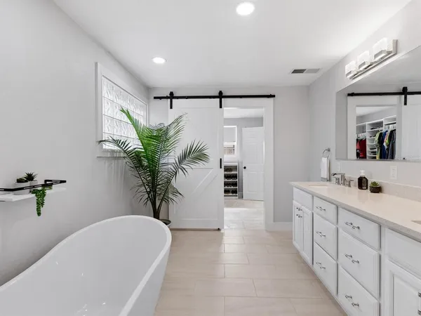 a utility room with sink dryer and washer