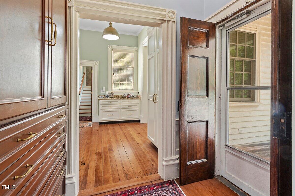 206 Shaver Road Macon, NC 27551 - Photo 26 of 68 a view of front door and bedroom with wooden floor