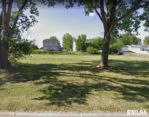 a view of a field with an trees