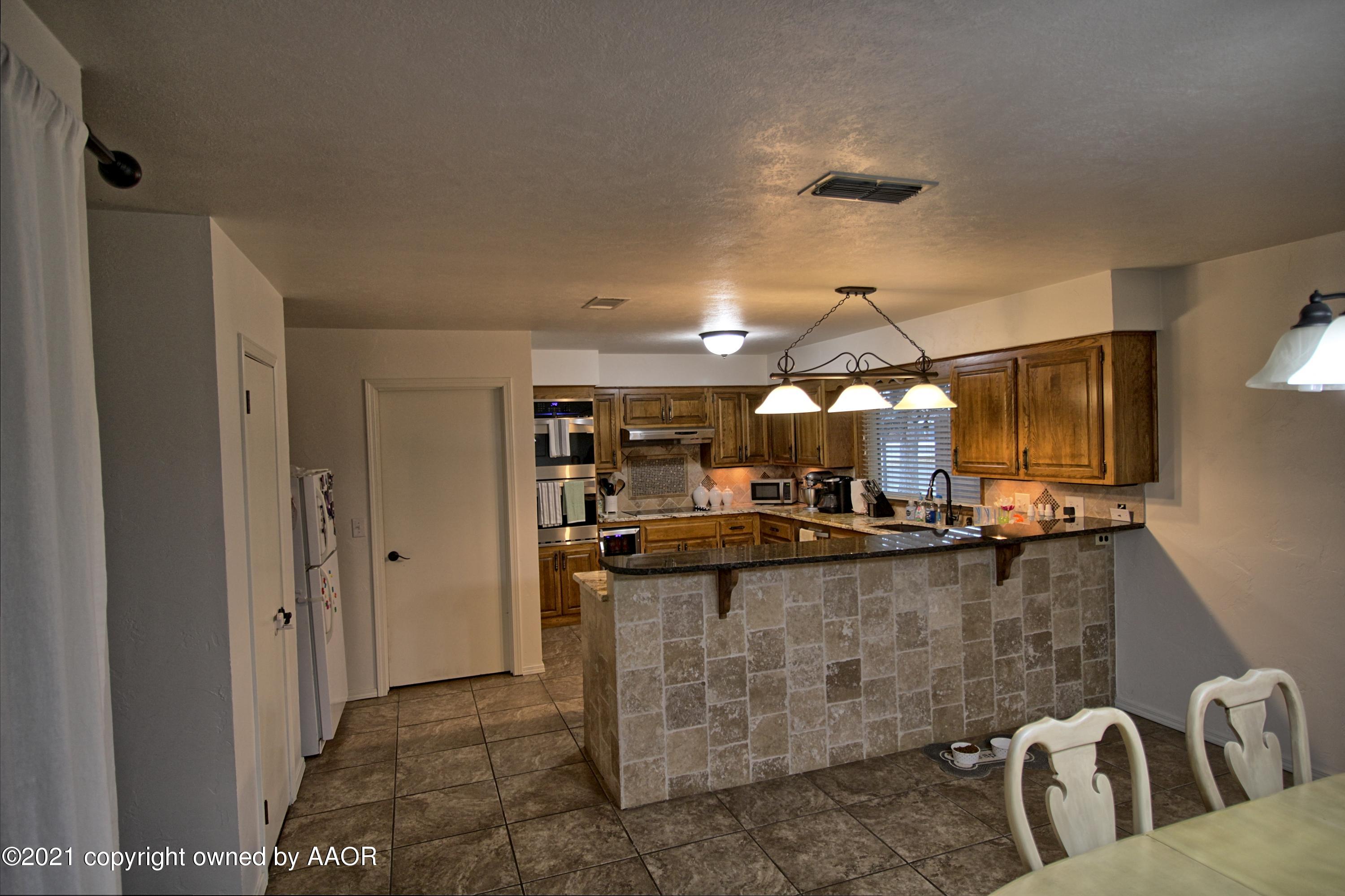2101 Southwest 21st Avenue Perryton, TX 79070 - Photo 5 of 20 a kitchen with counter top space and appliances