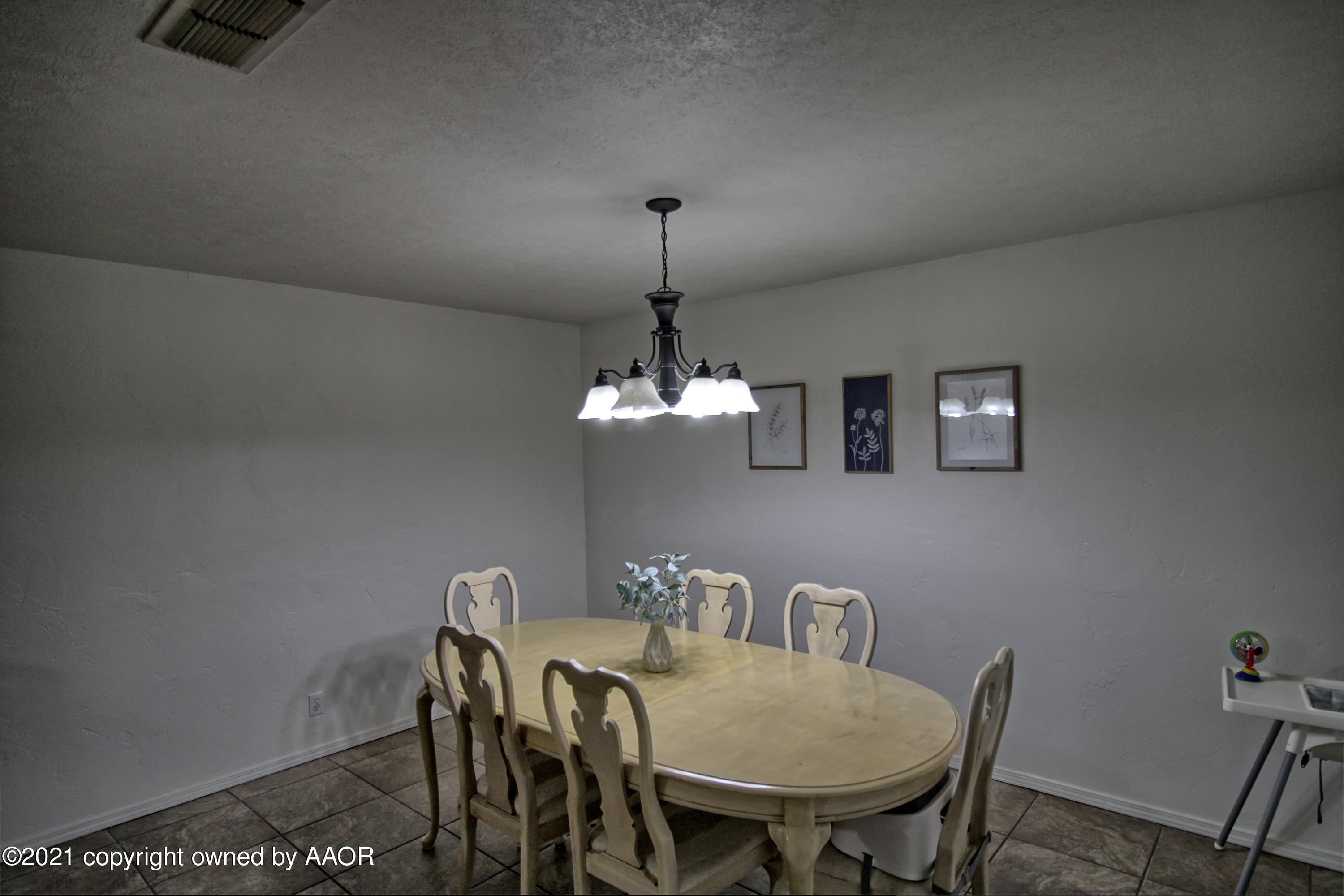 2101 Southwest 21st Avenue Perryton, TX 79070 - Photo 8 of 20 a view of a dining room with furniture and wooden floor