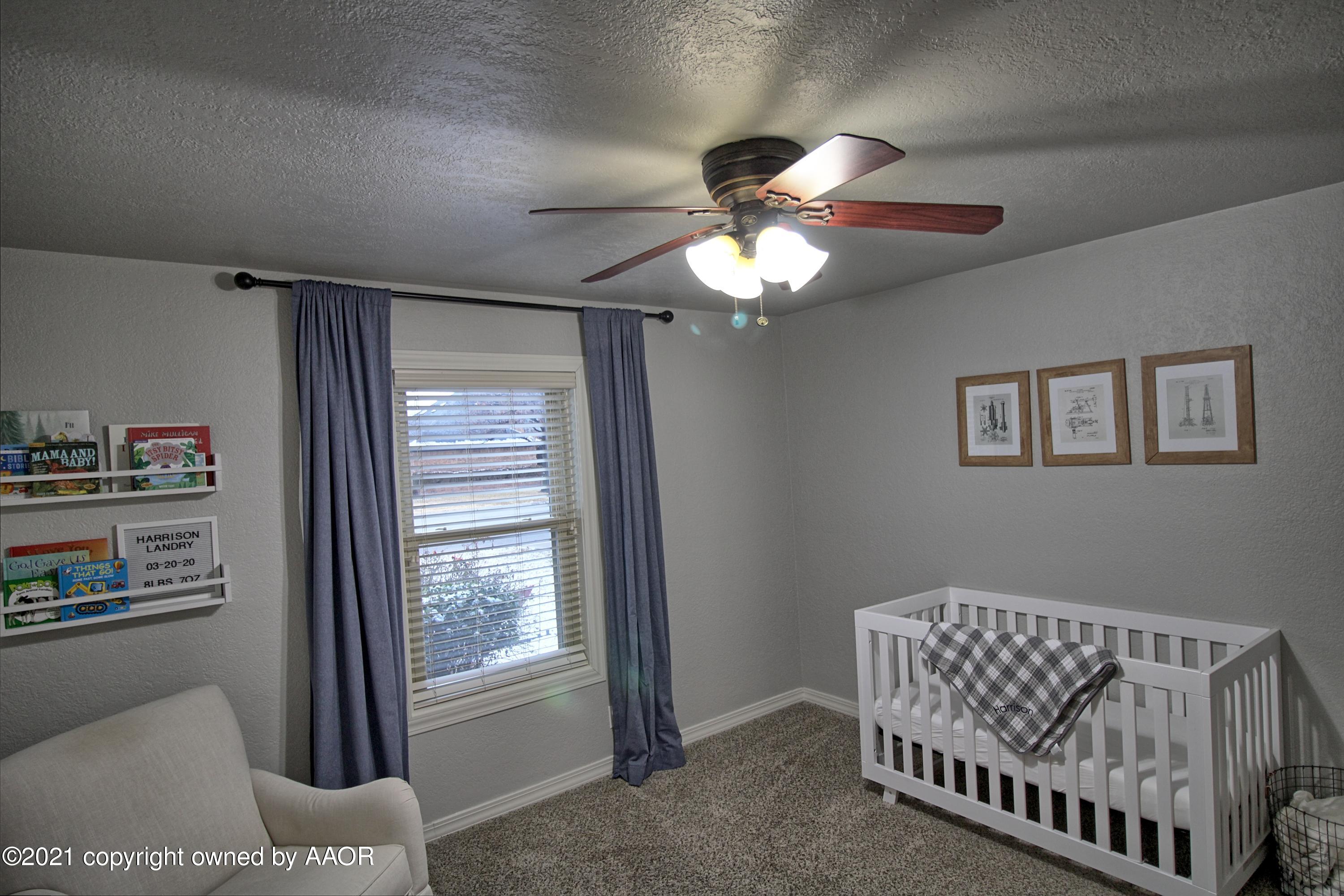 2101 Southwest 21st Avenue Perryton, TX 79070 - Photo 10 of 20 a bedroom with furniture and a window