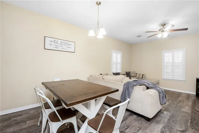 a view of a dining room with furniture and window