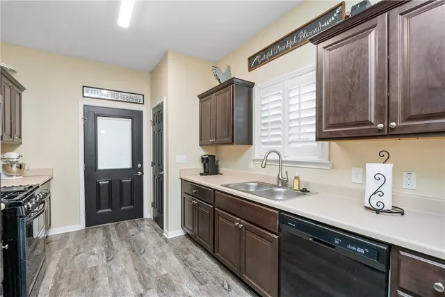 a kitchen with a sink stove and cabinets