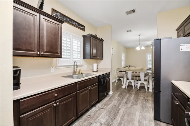 a kitchen with lots of counter top space and stainless steel appliances
