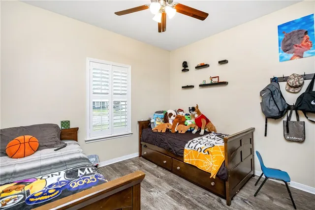 a room with a bed and wooden floor