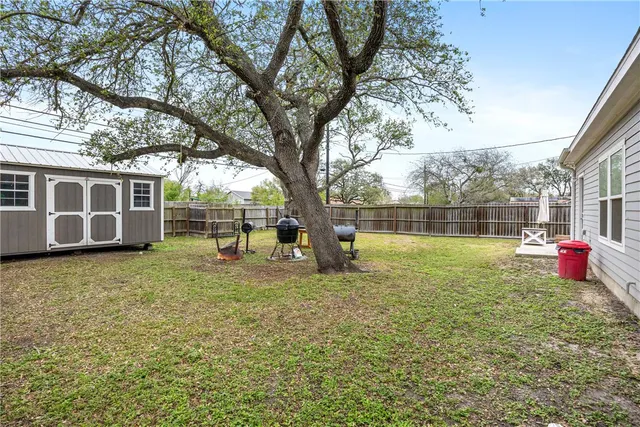 a backyard of a house with table and chairs