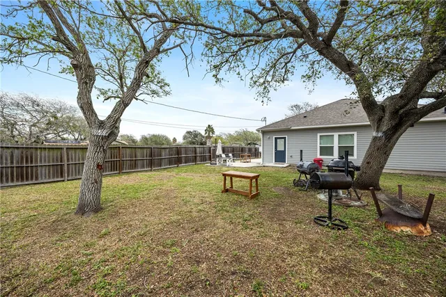 a view of house with backyard and outdoor seating