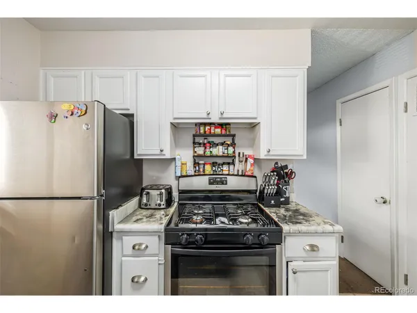 a kitchen with a stove and a refrigerator