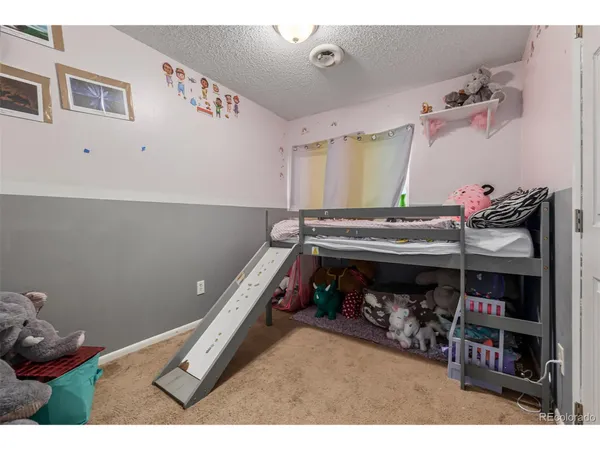 a bedroom with a bed and a book shelf
