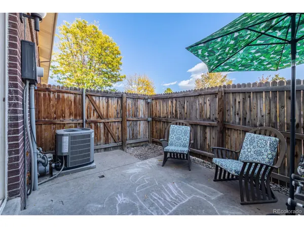 a view of a chairs and tables in the back yard of the house