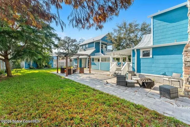 a front view of a house with garden and patio