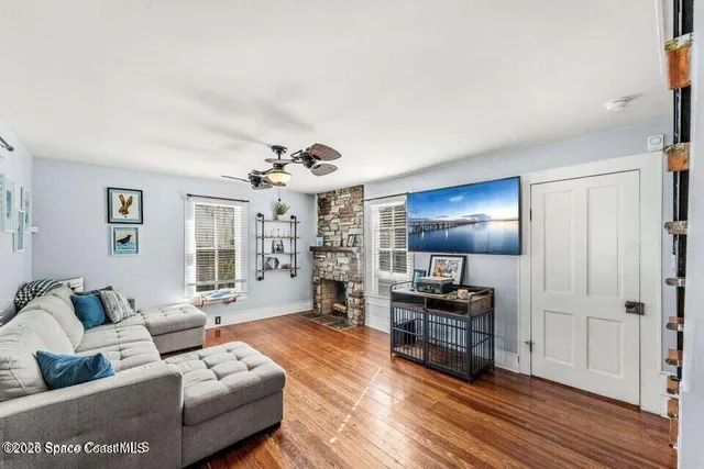 a living room with furniture and wooden floor