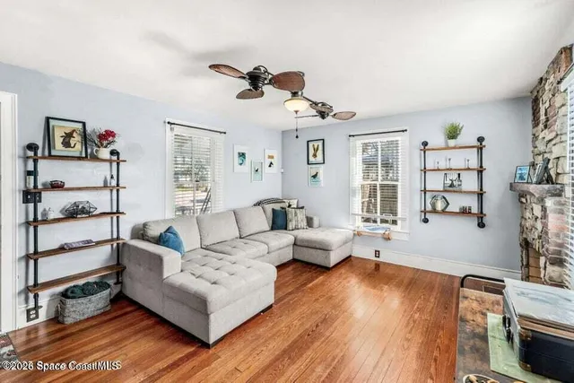 a living room with furniture and a wooden floor