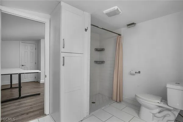a bathroom with a shower a toilet and a sink