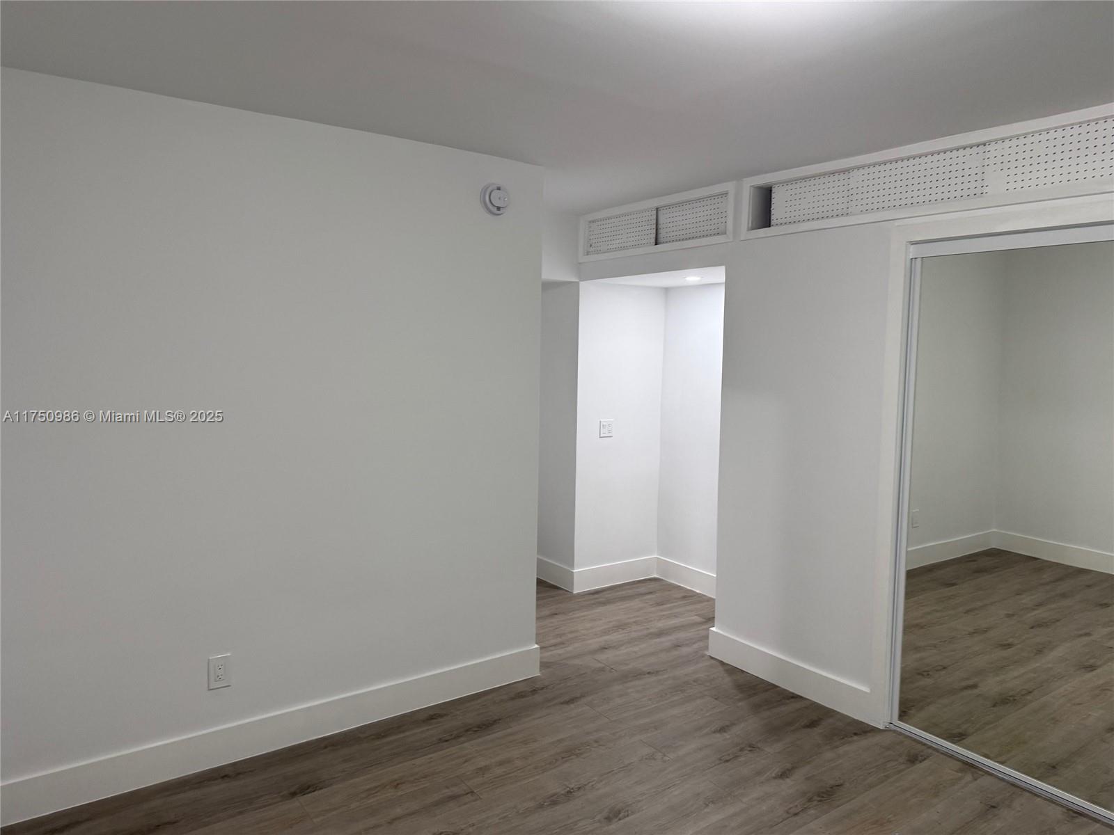 926 Michigan Avenue, Unit 12 Miami Beach, FL 33139 - Photo 5 of 14 a view of an empty room with wooden floor