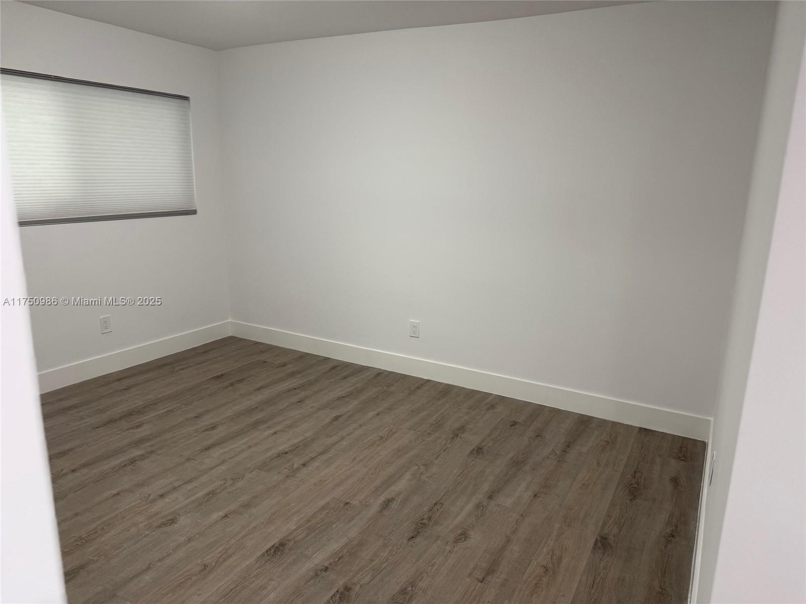 926 Michigan Avenue, Unit 12 Miami Beach, FL 33139 - Photo 6 of 14 wooden floor in an empty room