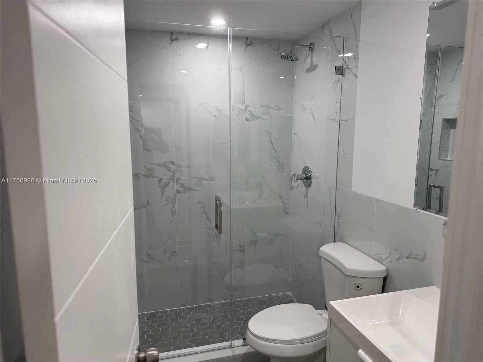 926 Michigan Avenue, Unit 12 Miami Beach, FL 33139 - Photo 7 of 14 a bathroom with a toilet and shower