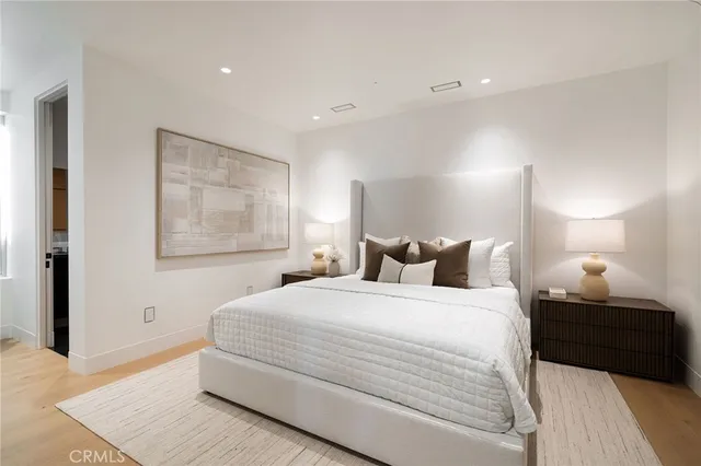 a bedroom with a bed and a lamp