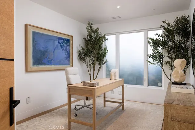a view of a livingroom with furniture and a potted plant