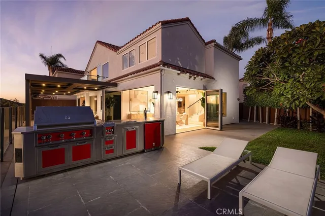 a view of a chairs and tables in the back yard of a house
