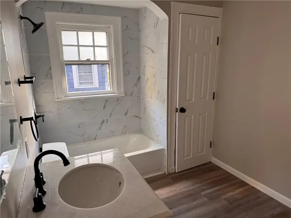 a bath tub sitting next to a window