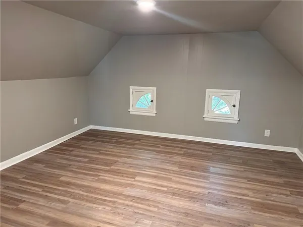 a view of a room with wooden floor and window
