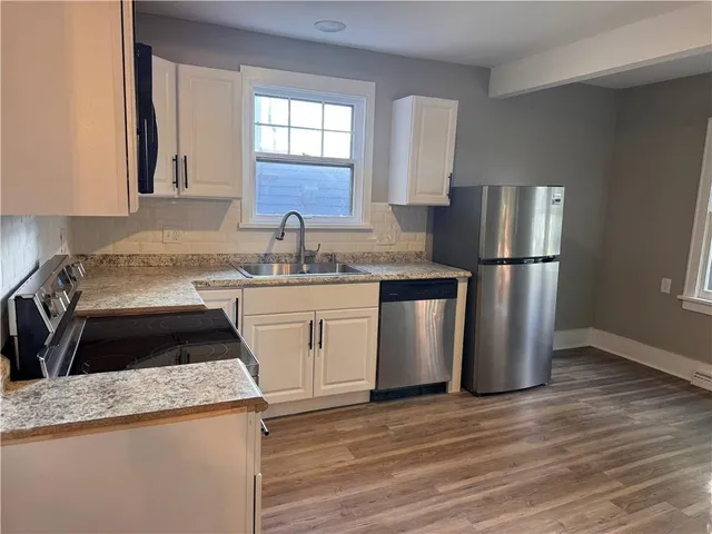 a kitchen with a sink stove and refrigerator