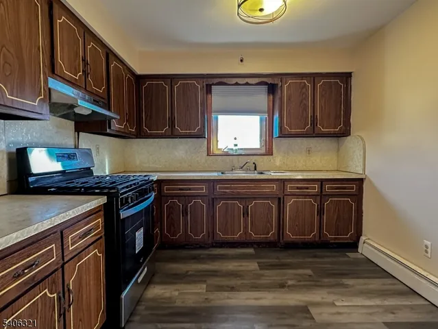 a kitchen with stainless steel appliances granite countertop a stove and a sink