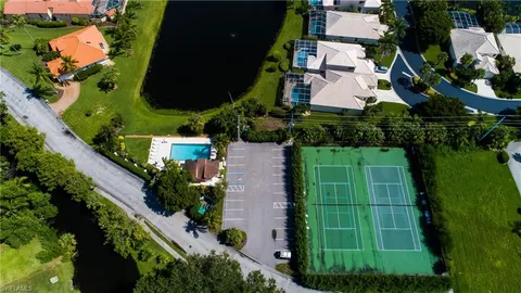 an aerial view of residential houses with outdoor space and swimming pool
