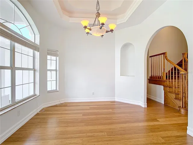 a kitchen with stainless steel appliances and chandelier