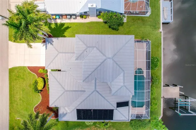 a view of an ocean with boats and trees in the background