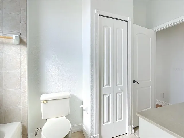 a living room with stainless steel appliances kitchen island granite countertop a refrigerator and a view of living room