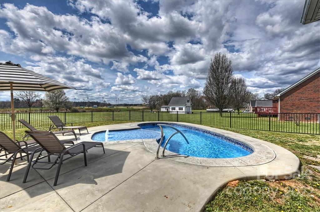 3708 Zebulon Williams Road Monroe, NC 28110 - Photo 32 of 48 a swimming pool with outdoor seating and city view