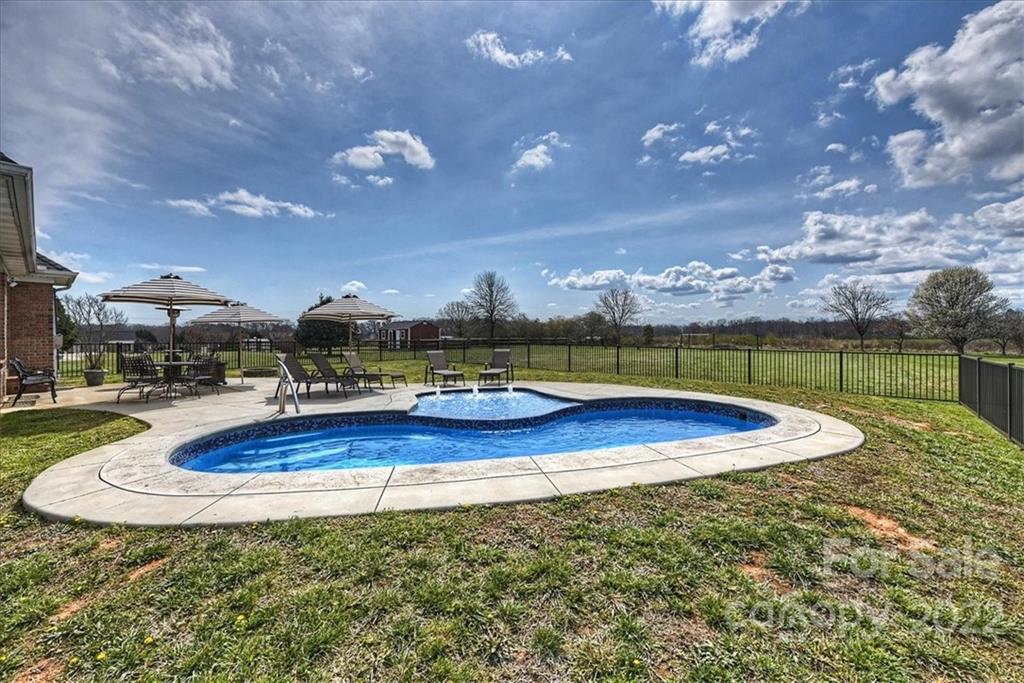 3708 Zebulon Williams Road Monroe, NC 28110 - Photo 36 of 48 a view of a swimming pool with an outdoor seating and a yard